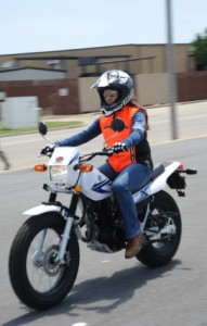 Person on motorcycle with vest and helmet taking a test