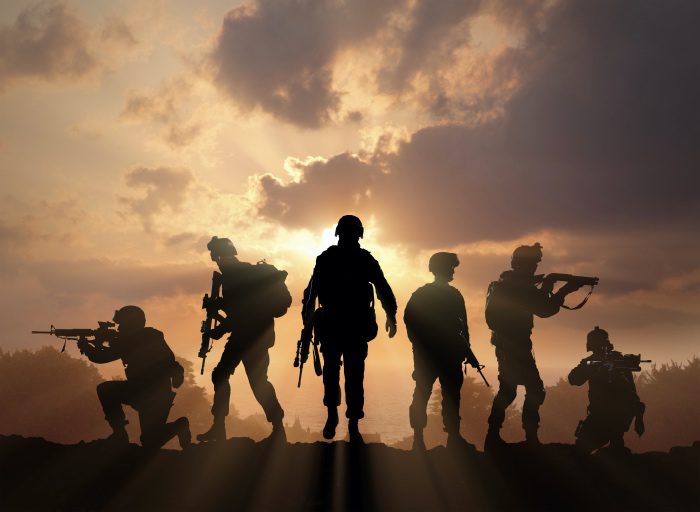 SOLDIERS ON A HILL ON A HILL AT SUNSET
